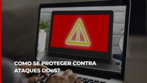 Tela de computadoe vermelha, com um símbolo de exclamação que remete a perigo e o seguinte texto: como proteger seu site contra ataques DDoS?